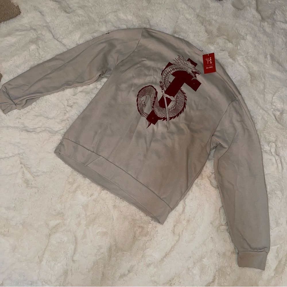 Locally made tan crewneck with Japanese lettering and red dragon with cross
